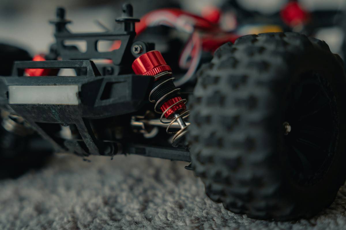 rc car simulator game showing a detailed cockpit view with steering wheel, telemetry HUD, and off-road track