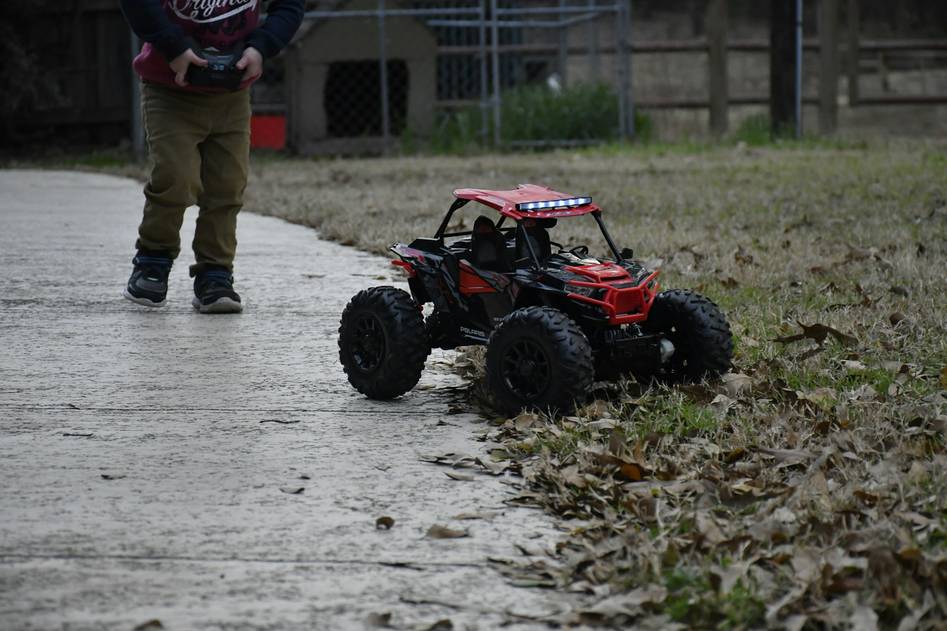 Team of RC car enthusiasts working on custom builds in a garage workshop
